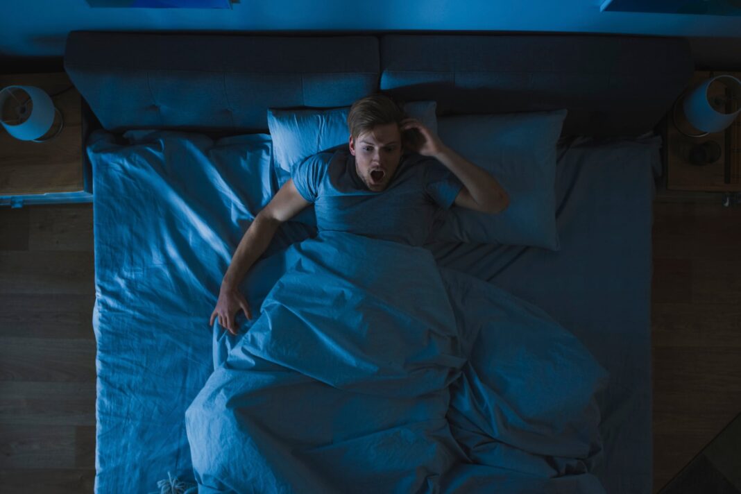 Persona durmiendo plácidamente en una cama, ilustrando un buen descanso nocturno.