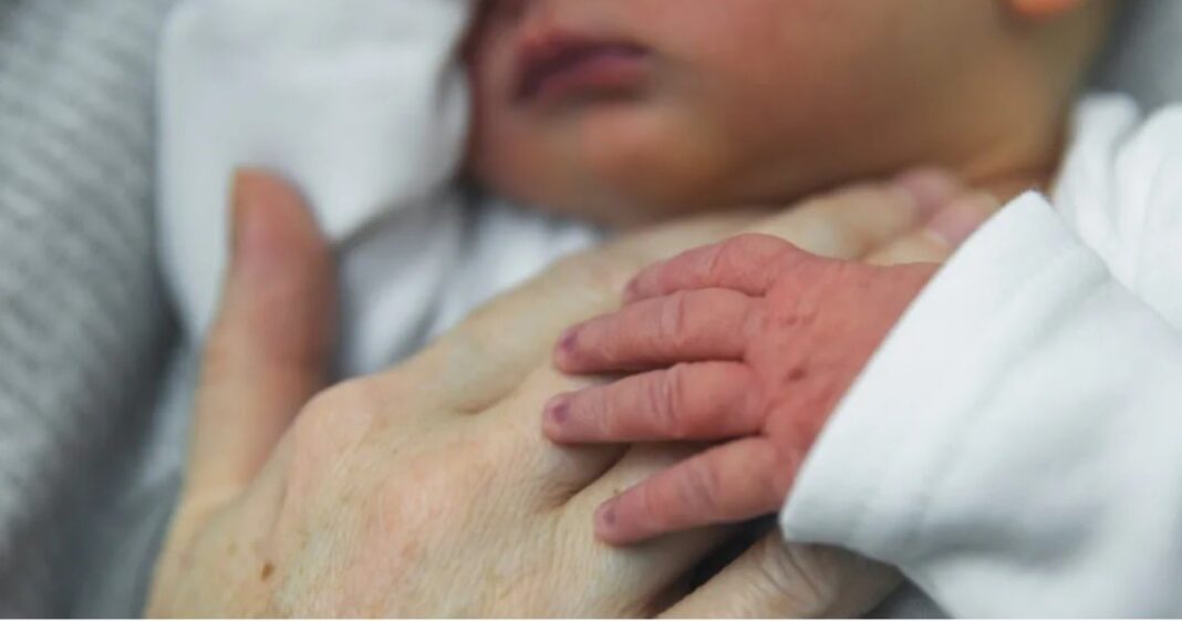 Voluntaria abrazando a un bebé en el programa Abrázame en un hospital de Santiago de Chile