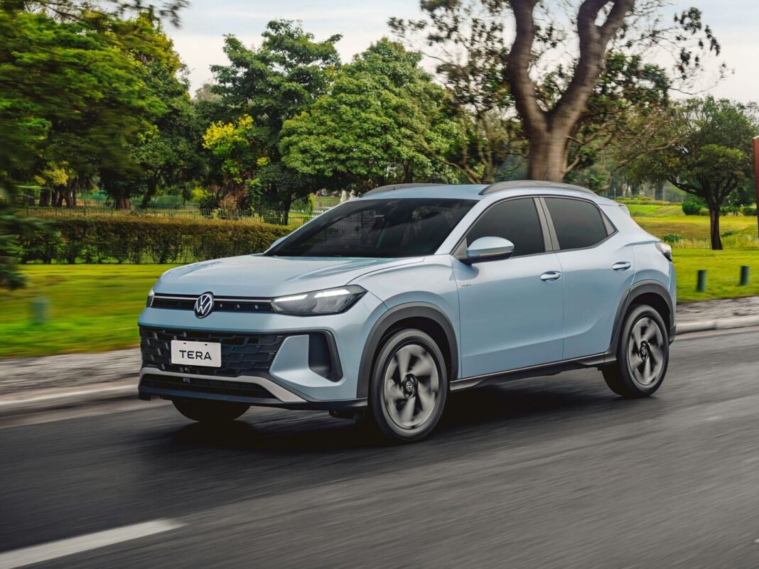 Logo de Volkswagen junto a un automóvil de la marca en un concesionario